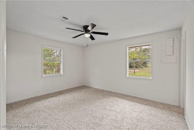 spare room featuring a ceiling fan, carpet, visible vents, and baseboards