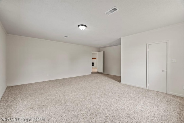 unfurnished room with light carpet, visible vents, and ornamental molding