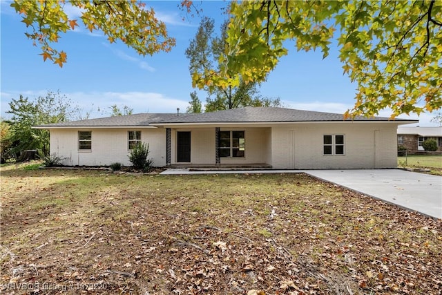 single story home with a front yard and brick siding