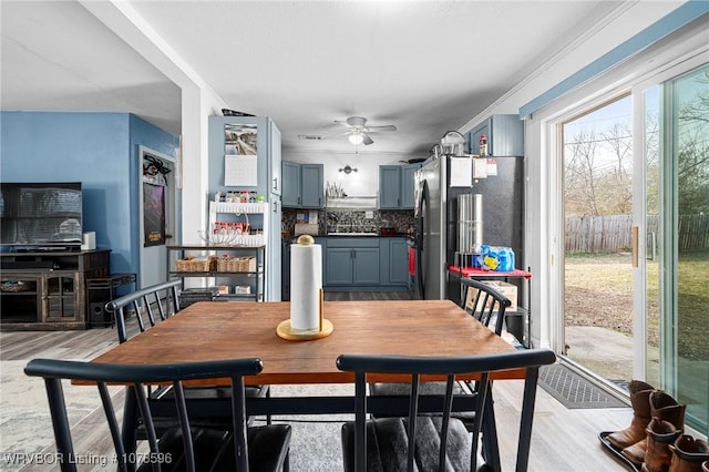 dining area with ceiling fan and light hardwood / wood-style floors