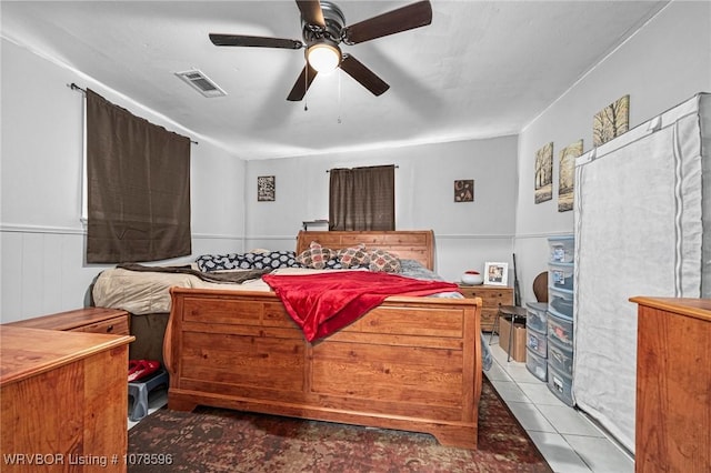 bedroom with ceiling fan and light tile patterned floors