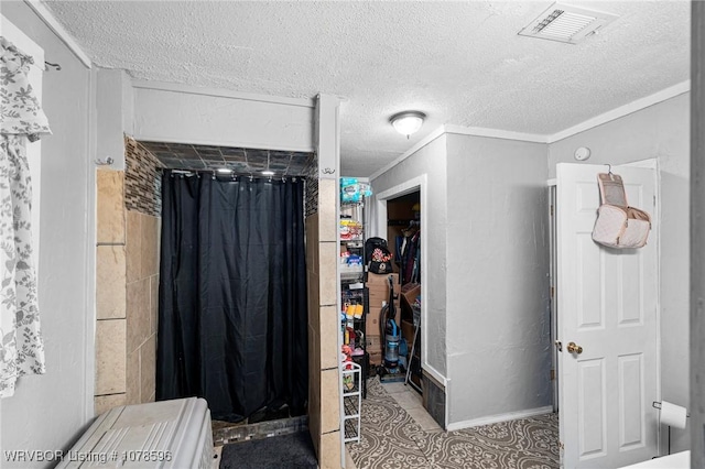 bathroom with crown molding, a textured ceiling, and a shower with shower curtain