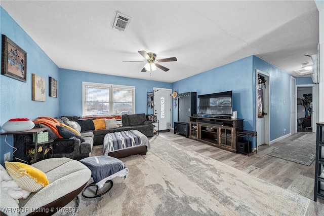 living room featuring ceiling fan and light wood-type flooring