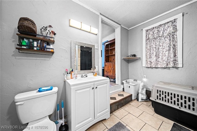 bathroom with tile patterned flooring, vanity, a textured ceiling, and toilet