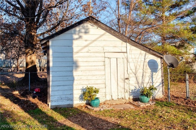 view of shed featuring fence