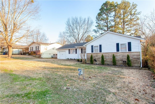 ranch-style home featuring an attached garage, stone siding, and a front lawn