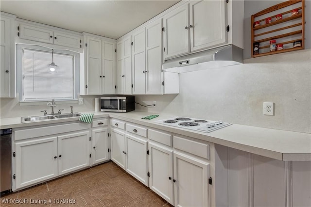 kitchen with stainless steel microwave, white cabinets, white electric cooktop, a sink, and under cabinet range hood