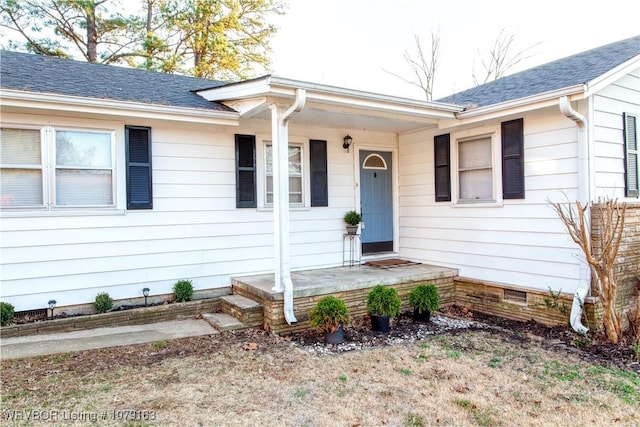 entrance to property featuring crawl space and roof with shingles