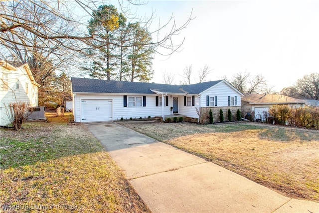 single story home with a garage, driveway, and a front lawn