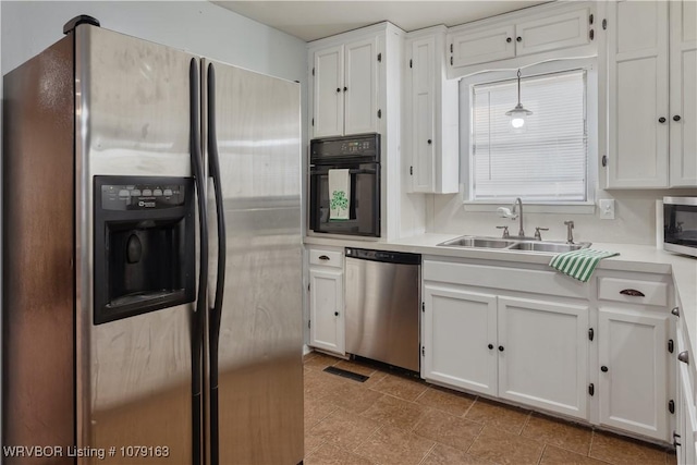 kitchen featuring light countertops, appliances with stainless steel finishes, a sink, and white cabinets