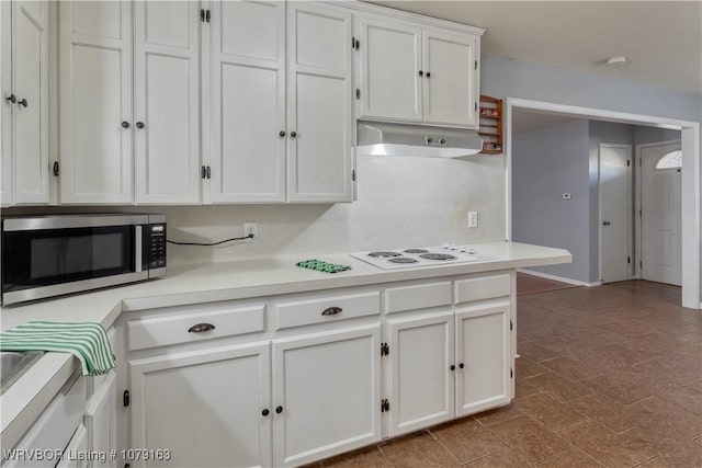 kitchen featuring white electric stovetop, light countertops, stainless steel microwave, white cabinets, and under cabinet range hood