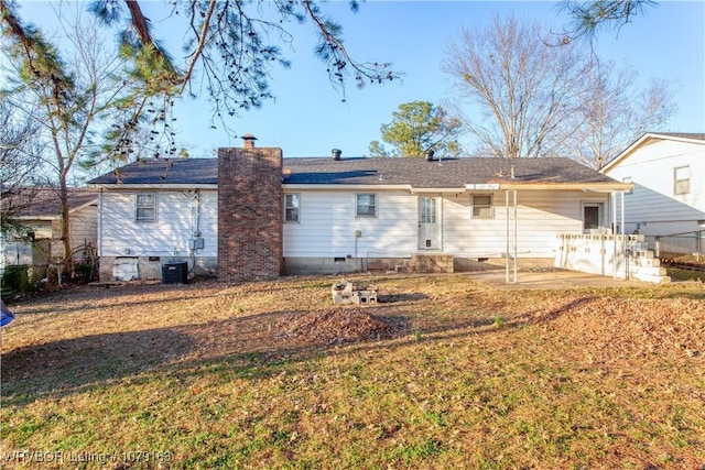 rear view of property featuring a yard, a chimney, crawl space, central AC, and fence