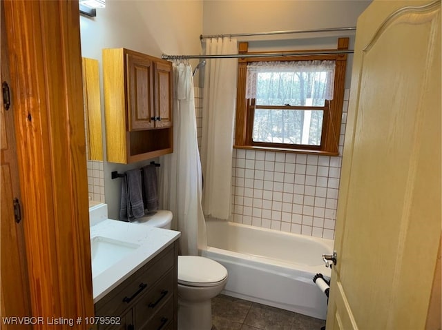 full bathroom featuring tile patterned flooring, toilet, vanity, and shower / bath combo with shower curtain