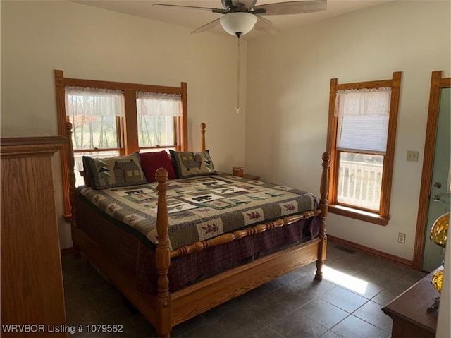 tiled bedroom featuring baseboards and ceiling fan