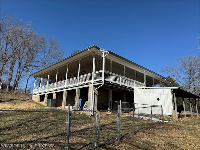 rear view of house with central air condition unit and fence