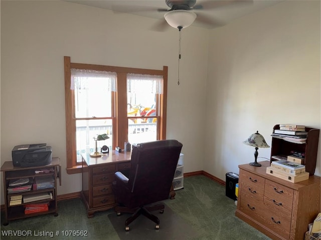 carpeted office featuring ceiling fan and baseboards