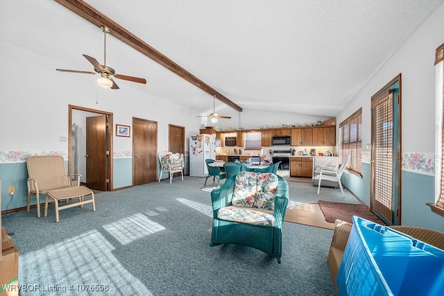 carpeted living room with vaulted ceiling with beams, ceiling fan, and a textured ceiling