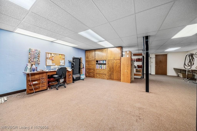 carpeted home office with a drop ceiling