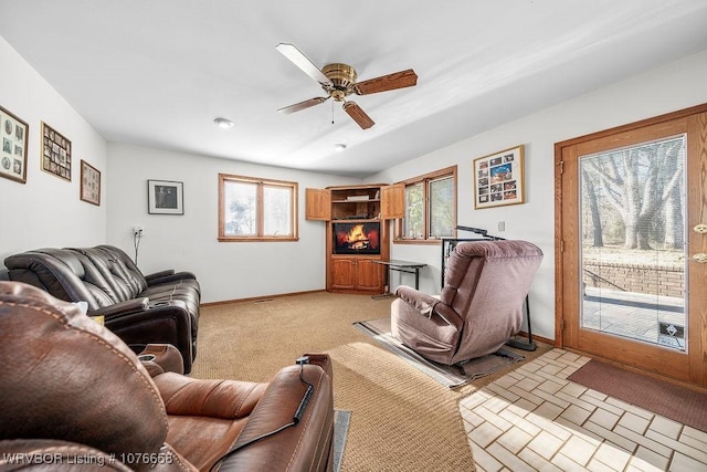 living room with plenty of natural light and ceiling fan