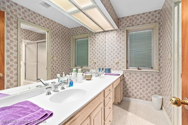 bathroom with tile patterned flooring, vanity, and a shower with shower door