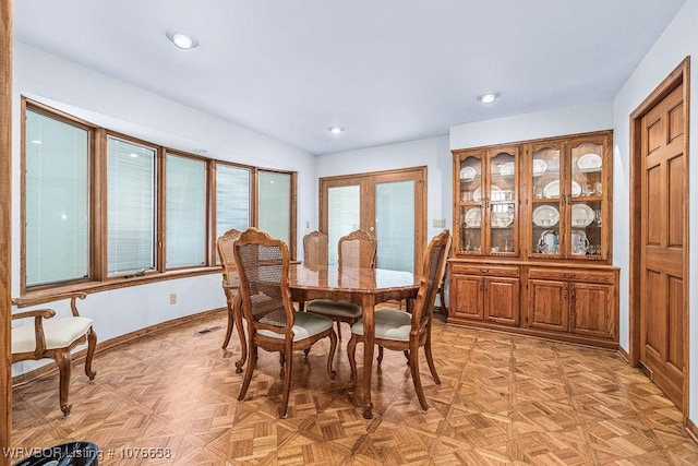 dining space featuring light parquet floors