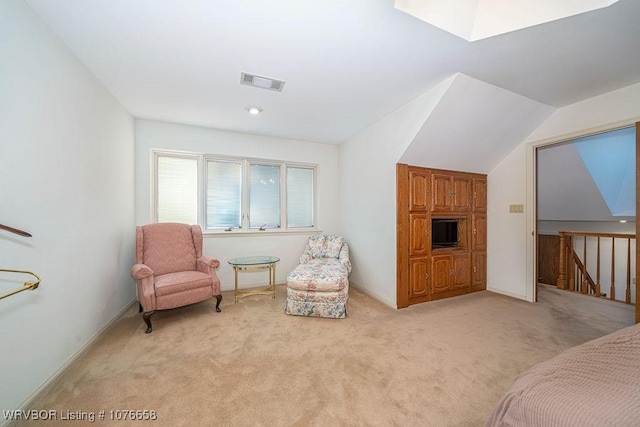 sitting room featuring light carpet and vaulted ceiling