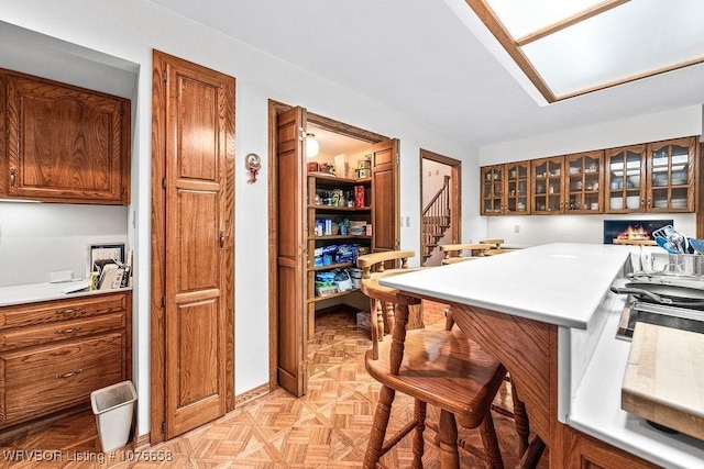 kitchen featuring a breakfast bar area and light parquet flooring