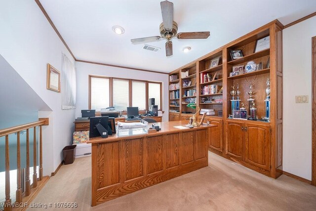 office space featuring light carpet, ceiling fan, and crown molding