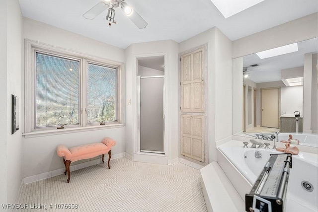 bathroom with a skylight, tile patterned floors, ceiling fan, and independent shower and bath