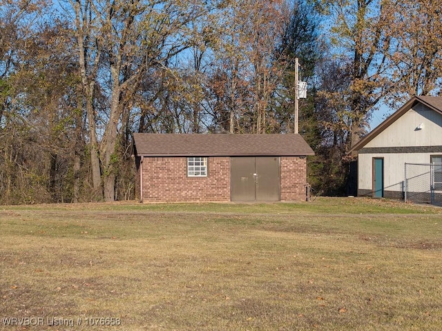 view of outdoor structure featuring a lawn