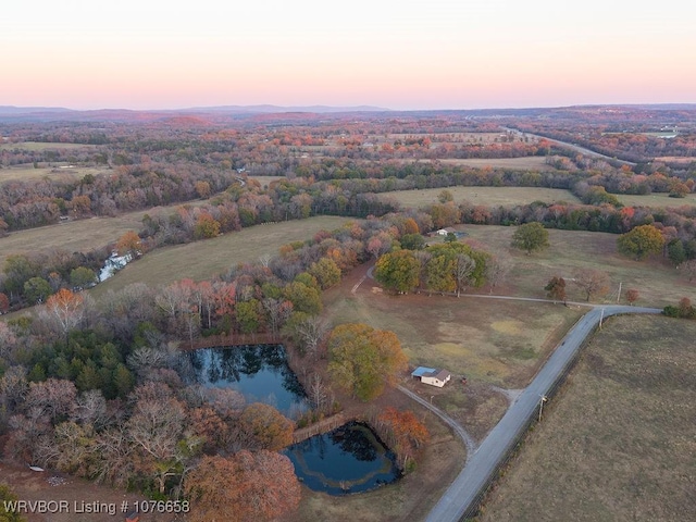 aerial view at dusk with a water view