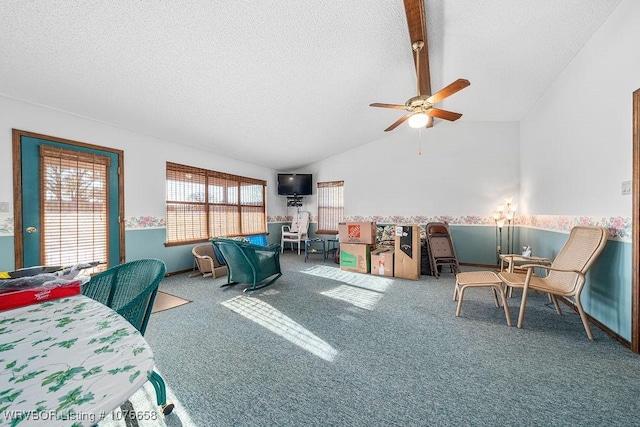 bedroom featuring a textured ceiling, ceiling fan, carpet, and lofted ceiling