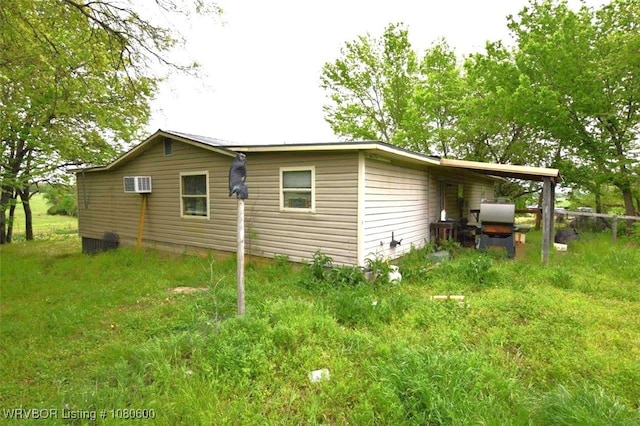 view of side of property featuring a wall unit AC