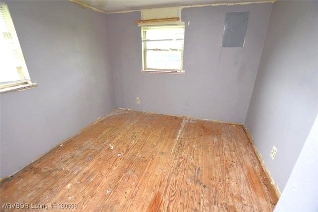 unfurnished room featuring hardwood / wood-style floors and electric panel