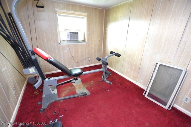 workout room featuring baseboards, cooling unit, and wooden walls