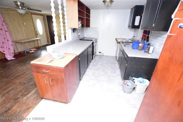 kitchen with stainless steel electric range oven, tasteful backsplash, open shelves, light countertops, and a ceiling fan