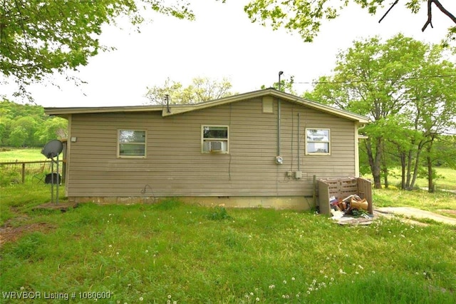 back of property featuring a yard and central AC unit
