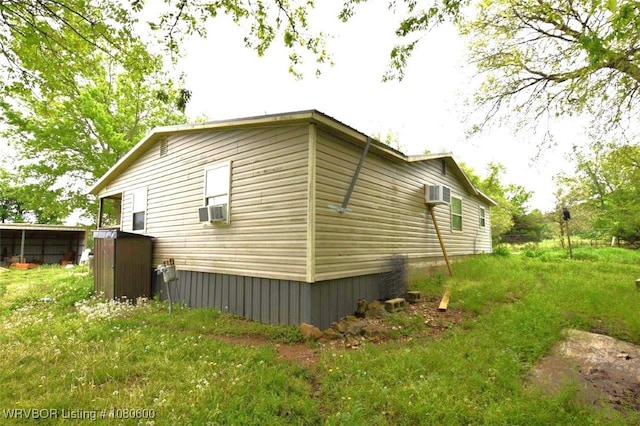 view of property exterior featuring cooling unit and a wall mounted AC