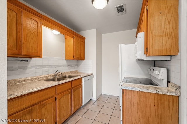 101 Saskatchewan Rd, Roland, OK 74954 - kitchen featuring white appliances, a sink, light tile patterned floors, light countertops, and backsplash