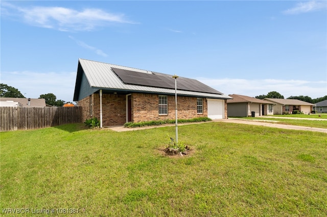 101 Saskatchewan Rd, Roland, OK 74954 - ranch-style house featuring driveway, roof mounted solar panels, an attached garage, and brick siding