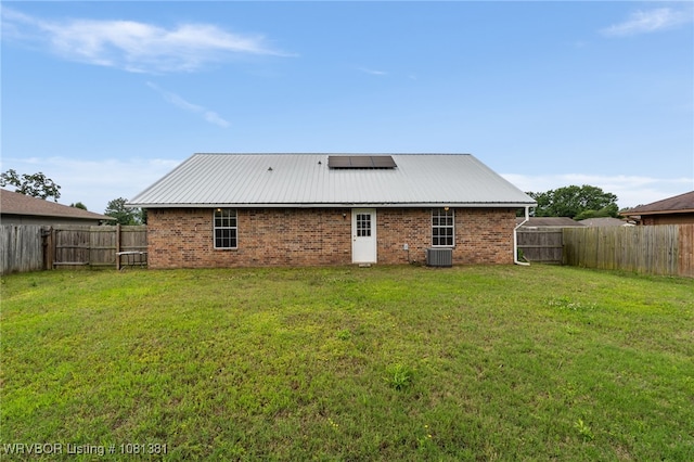 101 Saskatchewan Rd, Roland, OK 74954 - back of house with solar panels, metal roof, and brick siding