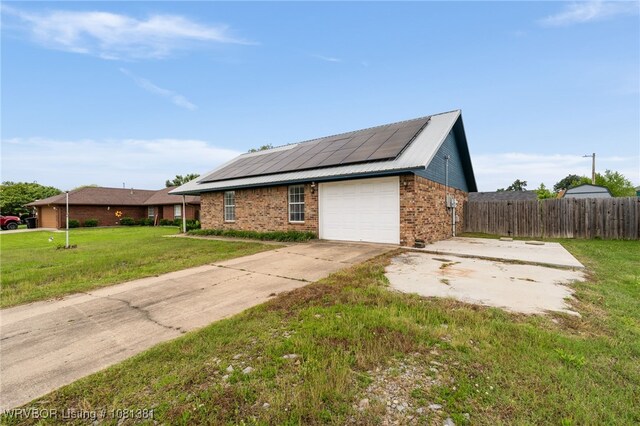 101 Saskatchewan Rd, Roland, OK 74954 - view of home's exterior with solar panels, brick siding, and concrete driveway