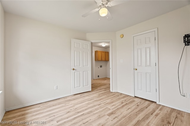 101 Saskatchewan Rd, Roland, OK 74954 - unfurnished bedroom with light wood-style floors, baseboards, and ceiling fan