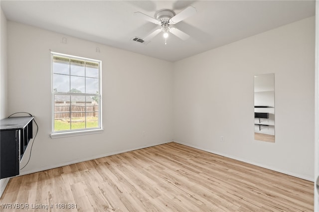 101 Saskatchewan Rd, Roland, OK 74954 - spare room featuring wood finished floors, plenty of natural light, a ceiling fan, and baseboards