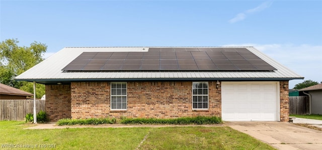 101 Saskatchewan Rd, Roland, OK 74954 - view of front of home featuring roof mounted solar panels, brick siding, a garage, and driveway