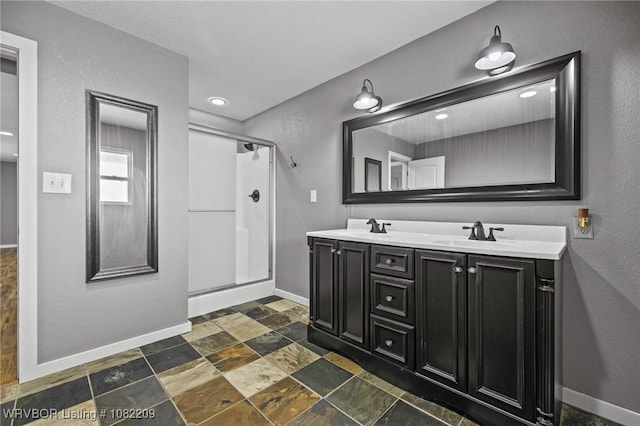6106 Dean Rd, Alma, AR 72921 - bathroom featuring a stall shower, double vanity, stone finish flooring, and recessed lighting