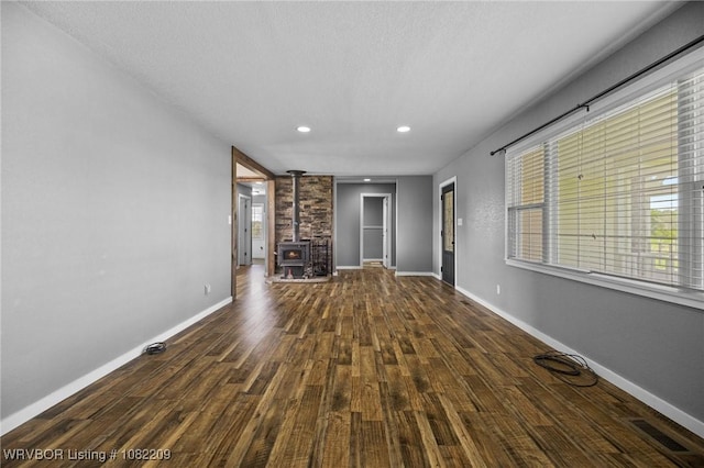 6106 Dean Rd, Alma, AR 72921 - unfurnished living room with wood finished floors, a wood stove, and recessed lighting