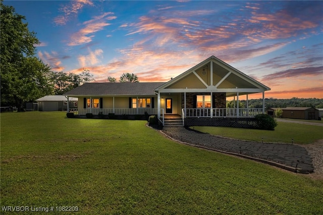 6106 Dean Rd, Alma, AR 72921 - view of front of home with a porch, a front lawn, and a shed