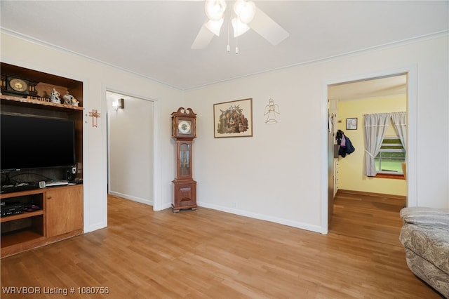 605 6th St, Barling, AR 72923 - living area featuring light wood-style floors, ornamental molding, baseboards, and ceiling fan