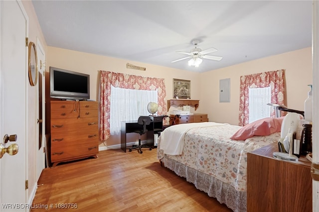 605 6th St, Barling, AR 72923 - bedroom with baseboards, light wood-style flooring, ceiling fan, and electric panel